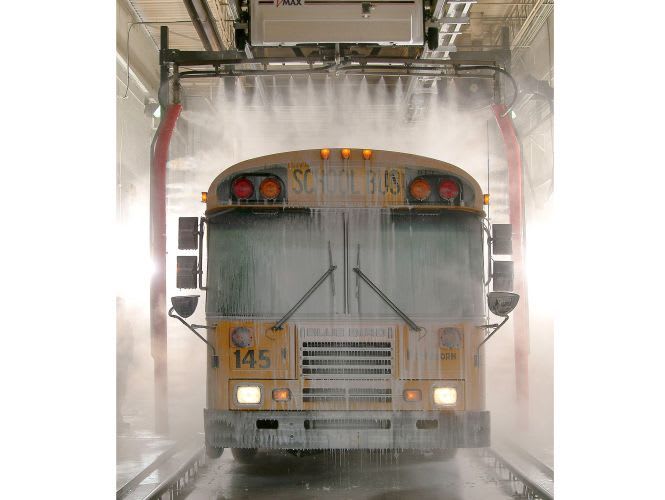 School bus being washed in a Belanger automatic wash bay