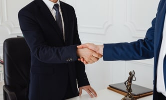two men in suits shaking hands