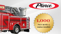 Pierce fire truck with aerial ladder alongside graphic noting 1,000 PACCAR MX-13 engines installed, marking a milestone in fire apparatus production.