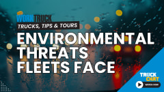 Darkened background image of blurred car lights in rainy traffic, logos for Work Truck and Truck Chat, and headline Environmental Threats Fleets Face.