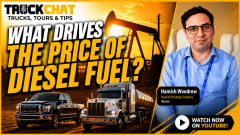 YouTube thumbnail featuring a dramatic orange-and-gold oilfield sunset with a large oil pumpjack in the background. In the foreground are a black diesel pickup truck and a silver fuel tanker semi-truck positioned along the bottom of the image. Large bold text in white and yellow reads “WHAT DRIVES THE PRICE OF DIESEL FUEL?