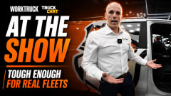 Work Truck Truck Chat thumbnail featuring a Sheldon Zitzmann standing beside a white work truck at a trade show. Large text reads “AT THE SHOW” and “TOUGH ENOUGH FOR REAL FLEETS” with Work Truck and Truck Chat branding in the upper left corner. The speaker gestures toward the truck interior while discussing fleet-focused floor liner solutions.