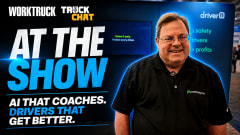 Work Truck Truck Chat thumbnail featuring a Netradyne representative standing at a trade show booth beside large text reading “AI That Coaches. Drivers That Get Better.”