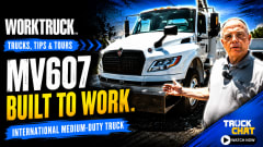 Promotional thumbnail for a Work Truck “Trucks, Tips & Tours” video featuring an International MV607 medium-duty truck and a presenter. Large text reads “MV607 Built to Work,” with a Truck Chat “Watch Now” callout.