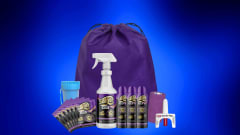 SoRite decontamination products, including spray bottles, aerosol cans, wipes, a purple drawstring bag, tape, container, and nasal spray, arranged against a glowing blue background.