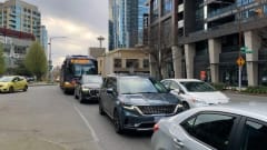 A Route 8 bus travels on Denny Way in congested traffic.