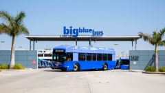 A California zero-emission Big Blue Bus parked outside a bus depot.