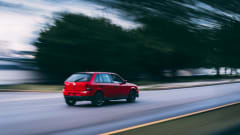 Blurred photo of red car moving down a road