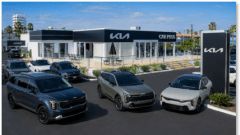 outside of car dealership with cars parked in front