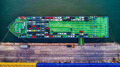 Overhead view of container cargo ship loaded with vehicles