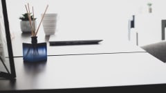 Photo of essential oil diffuser on desk next to laptop
