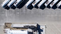 A drone shot of vehicles parked. 