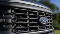 front grill of a Ford truck with blue Ford emblem