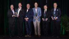 Group photo of men holding awards.