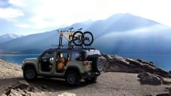Photo of a parked Jeep Recon with a mountain peak in the background