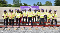Governor Moore in a ceremony placing the last track
