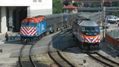 Two Metra locomotives on rail tracks.