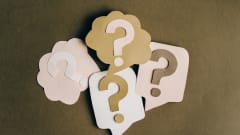 Several illustrations of question marks on a surface