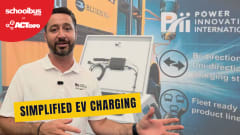 Billy Murphy of Power Innovations International speaks at ACT Expo in front of a display featuring EV charging equipment and a Blue Bird school bus graphic. A text overlay reads “Simplified EV Charging.”