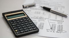 Photo of document next to calculator and inkpen