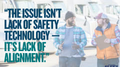 Two trucking industry workers talk in front of semi-trucks beside text reading, “The issue isn’t lack of safety technology — it’s lack of alignment.”