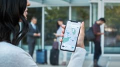 A rider looking at a Via map on a smartphone