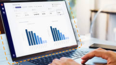 Laptop displaying HopSkipDrive RouteWise AI transportation analytics dashboard with charts and routing performance data for school district operations.