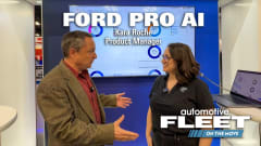 Kara Roche demonstrates Ford Pro AI telematics platform at Work Truck Week 2026, showing conversational dashboard for real-time fleet data analysis on screen.