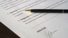 Insurance contract signature page with black inkpen on top