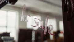 'for sale' written on a building window