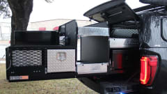 Truck bed storage system with open compartments and diamond plate panels