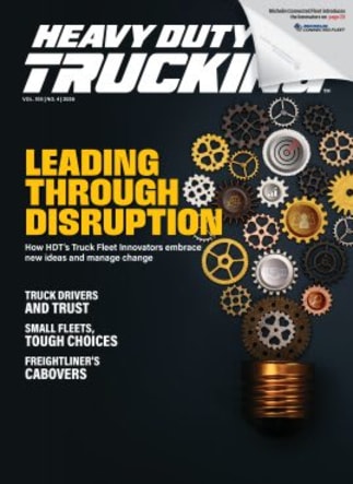 Heavy Duty Trucking magazine cover with black background, lightbulb graphic made with various gears