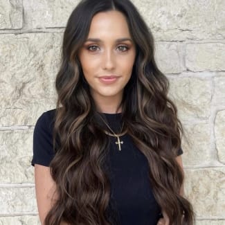 A woman with long brunette hair.