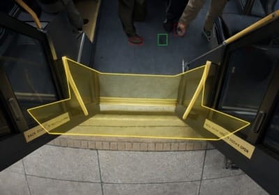 An image of a doorway on a public transit vehicle with a yellow outline overlay.