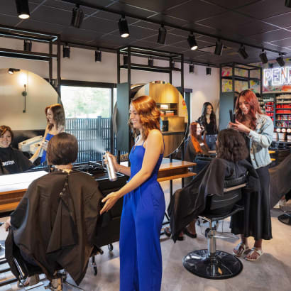 Stylists work with clients inside the training salon within BASE ONE, the PENZONE Salons+Spas' training center in Columbus, Ohio.