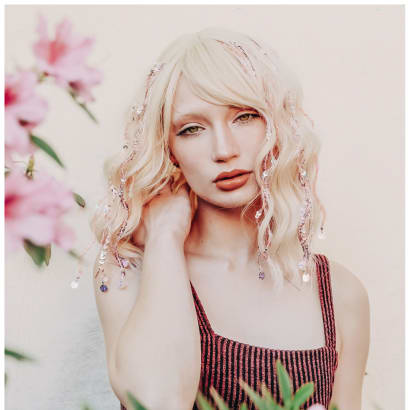 A blonde haired woman with tinsel strands.