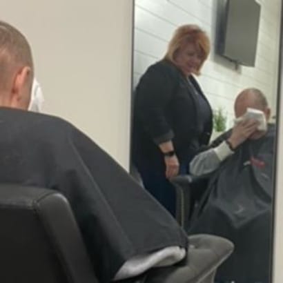 A hairstylist and her client, sitting in a chair