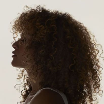 A woman with curly hair in profile.