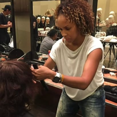 A hairdresser working in front of a client