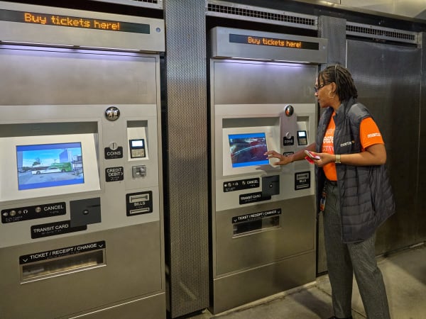 MARTA Deputy General Manager Rhonda Allen demonstrates how to use the better Breeze touchscreen ticket vending machines to purchase fare.