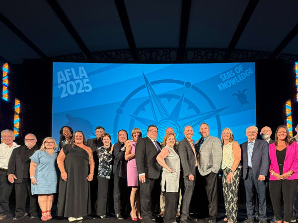 Honorees gather on stage for a photo. 