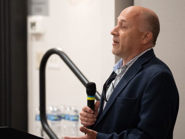 Man with microphone making presentation. 
