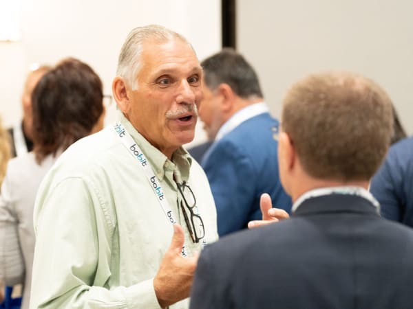 Man in discussion during networking break. 