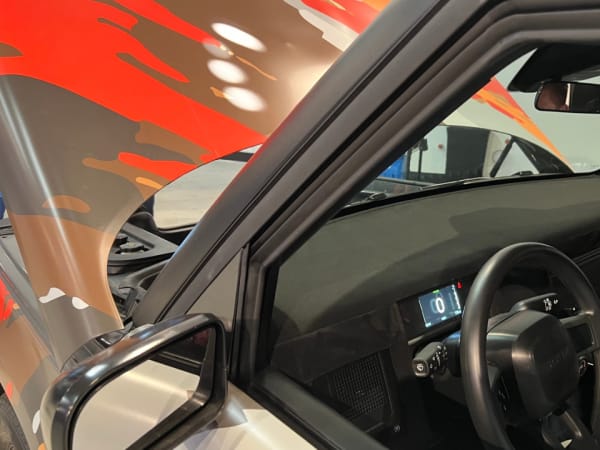 Photo of steering wheel and left dashboard.