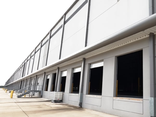 Exterior photo of a large building with multiple loading docks.