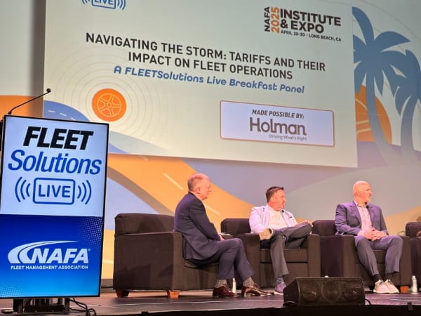 Panelists on stage during a seminar. 