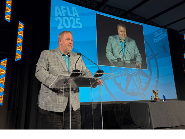 Man gives speech after accepting award.