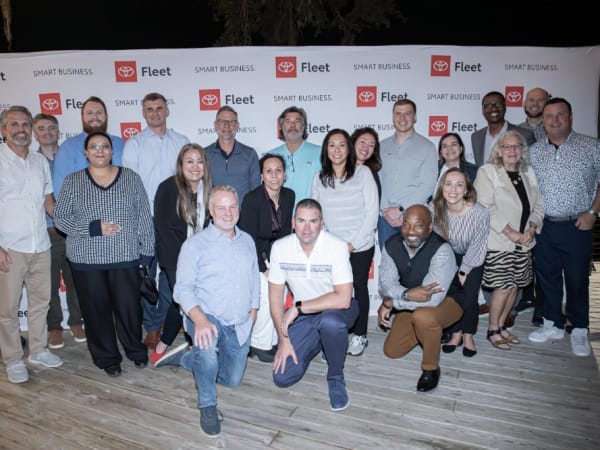 Large group poses for photo. 