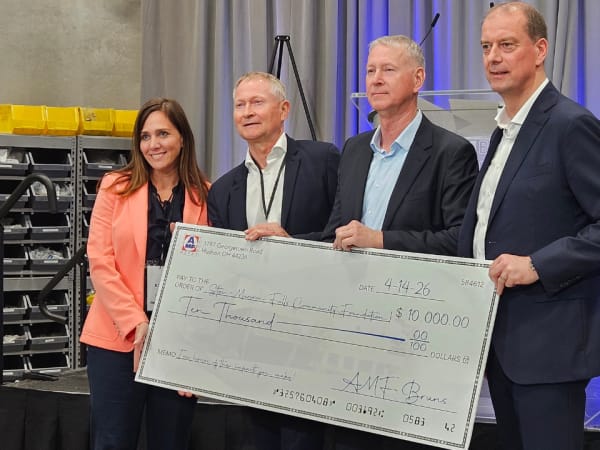 AMF executives and Stow-Monroe Falls Community Foundation pose with a check for $10,000.