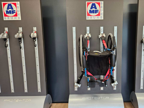 Wall-mounted wheelchair securement systems displayed in AMF Bruns showroom